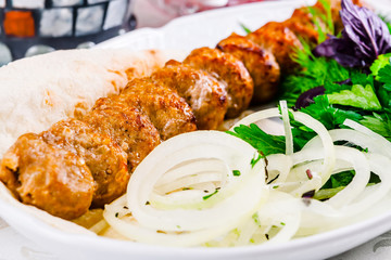 Mutton kebab with onion and herbs