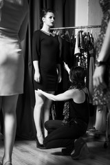 Fototapeta na wymiar Beautiful plus-size model preparing for a runway show in dress and with make up. Backstage