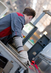 Factory man worker operating CNC forming machine at workshop