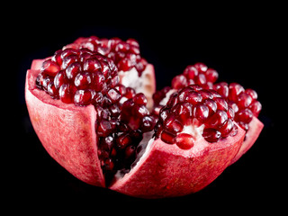 Detailed Red Pomegranate Fruit Cut Open Isolated by Black Background