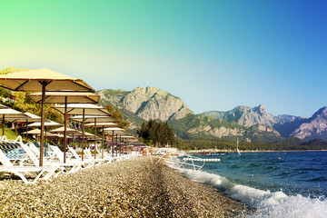 Sunshades and chaise lounges on beach. Summer seascape. Beautiful seaview. Turkey, Kemer.