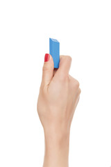 Female hand holds the eraser.