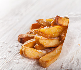 French fries in a little white paper bag.