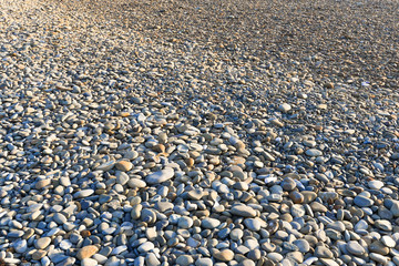 sea pebble texture grey at sunset