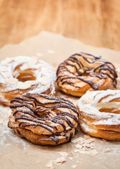 Chocolate and powdered sugar cream puff rings (choux pastry)