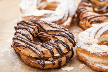 Chocolate and powdered sugar cream puff rings (choux pastry)