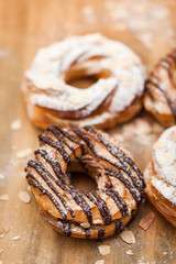 Chocolate and powdered sugar cream puff rings (choux pastry)