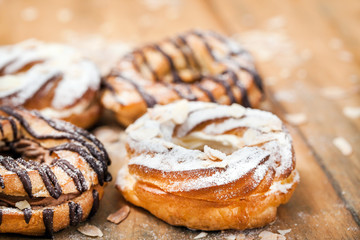 Chocolate and powdered sugar cream puff rings (choux pastry)