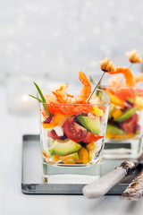 Shrimp, avocado, tomato, salmon and red caviar cocktail salad in