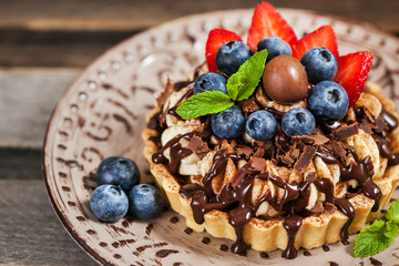 Banoffee chocolate pie decorated with chocolate, fresh blueberry