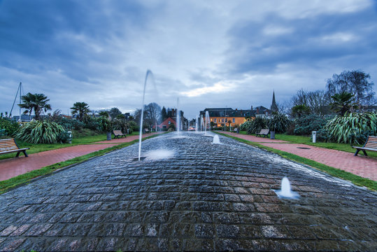 Water fontain in Carentan,France at dusk