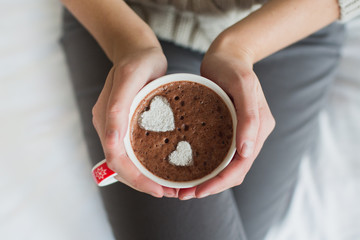 Woman hands holding a Cup of hot cocoa or  chocolate for  background, traditional drink  the winter...