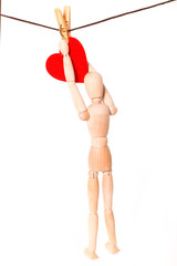 Wooden figure of the person and heart on a rope with a clothespe