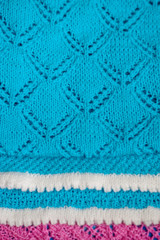 Blue baby blanket with a white border, hand-knitted