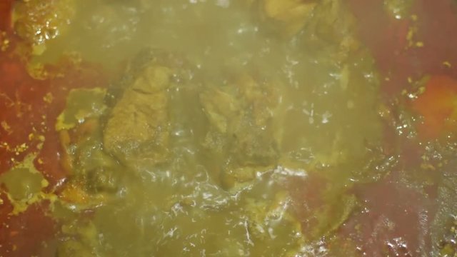 Beautiful close stock footage of Chicken curry cooking, boiling steam generating from hot gravy. It is a favourite dish amongst Bengalis of Kolkata, India.