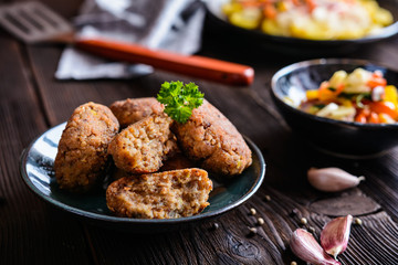 Vegetarian fritters made of buckwheat, bean, leek, garnished with potato and steamed vegetble