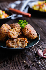 Vegetarian fritters made of buckwheat, bean, leek, garnished with potato and steamed vegetble