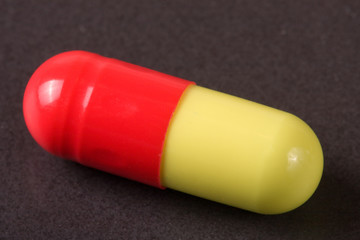 macro of red and yellow capsule pill isolated