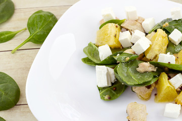 Garnished with cut feta salad from spinach, chicken and orange