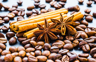 Coffee beans with cinnamon and anise on the sackcloth.