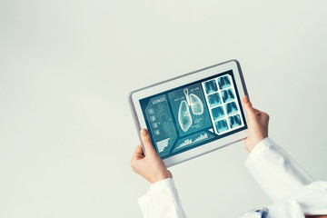 Close of female doctor hands working with tablet pc computer