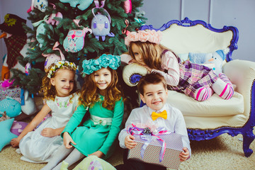 Lovely kids next to the Christmas tree