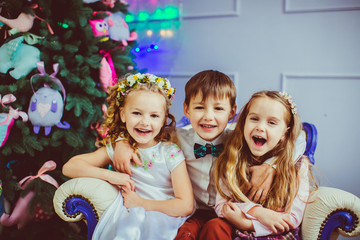 Little boy embraces two beautiful girls