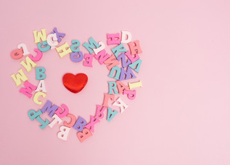 Vanlentine's day concept. Wooden color letters word love and red heart  on color background with copy space.watering can  love concept.