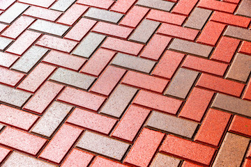 Fototapeta premium Red and grey paving stones as background close up