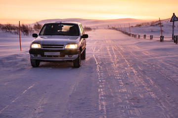 Car on the arctic road in day time. Murmansk Region, Russia