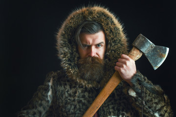 bearded man in fur with axe
