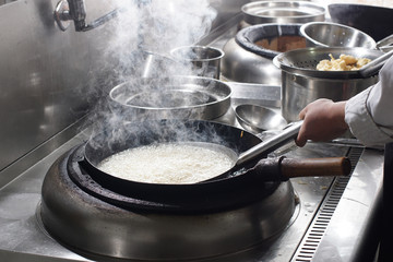 Close up of working chef preparing chinese food