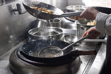 Close up of working chef preparing chinese food