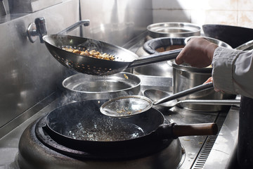 Close up of working chef preparing chinese food