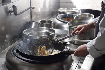 Close up of working chef preparing chinese food