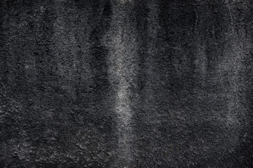 dark gray rough cracked plaster with streaks