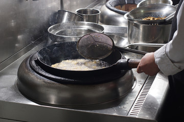 Close up of working chef preparing chinese food