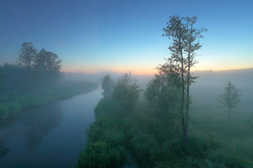 Landscape of misty morning on river
