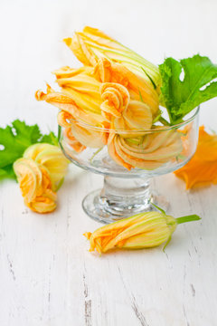 Edible  zucchini flowers on white background