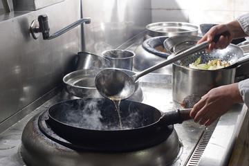 Close up of working chef preparing chinese food
