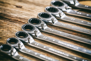 Set of wrenches on wooden background