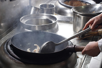 Close up of working chef preparing chinese food