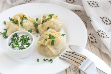 Traditional Turkish manti with sour cream sauce