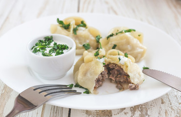 Traditional Turkish manti with sour cream sauce