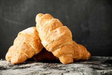Fresh croissant on scratched background