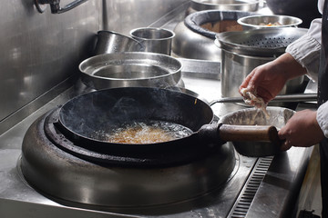 Close up of working chef preparing chinese food