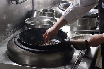 Close up of working chef preparing chinese food