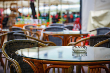 Street view of a coffee terrace with tables and chairs