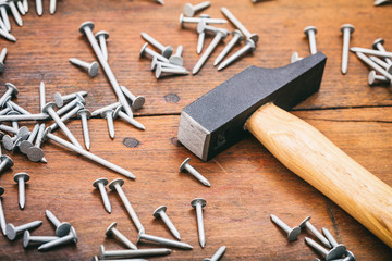 Hammer and nails on wooden background