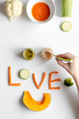 cooking vegetable puree for baby on white background top view